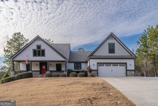 view of front of home featuring a porch and a garage