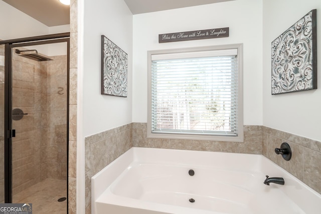 bathroom with separate shower and tub and a healthy amount of sunlight