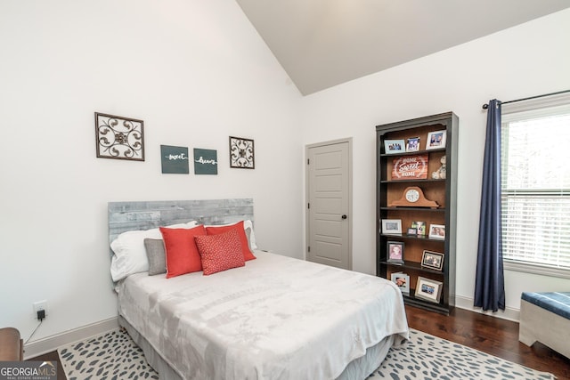 bedroom featuring vaulted ceiling and wood-type flooring