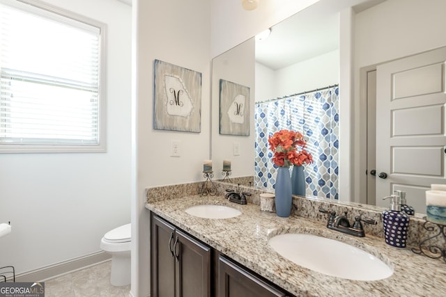 bathroom featuring toilet, vanity, and tile patterned floors