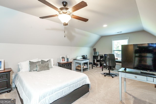 carpeted bedroom with ceiling fan and vaulted ceiling