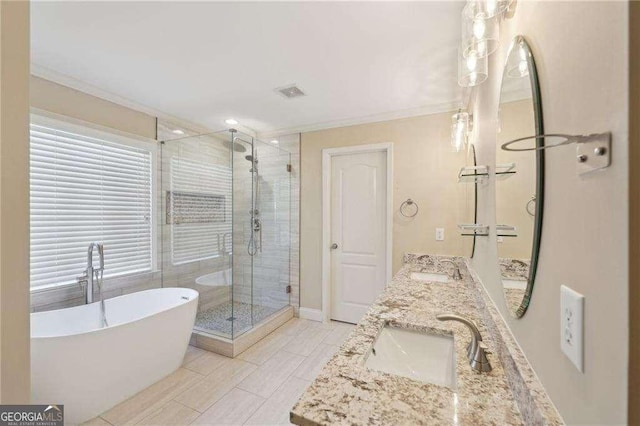 bathroom featuring tile patterned flooring, crown molding, vanity, and shower with separate bathtub