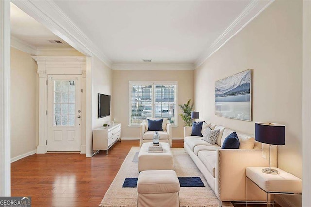 living room with hardwood / wood-style flooring and crown molding