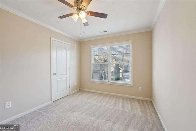 unfurnished room featuring light carpet, ceiling fan, and crown molding