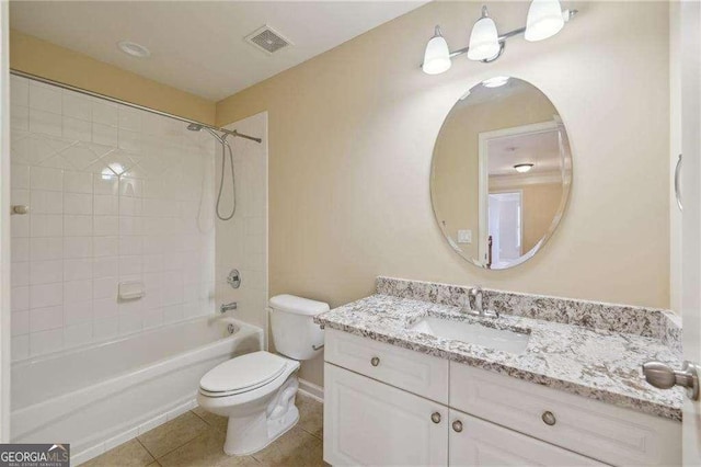 full bathroom with toilet, tiled shower / bath combo, tile patterned flooring, and vanity