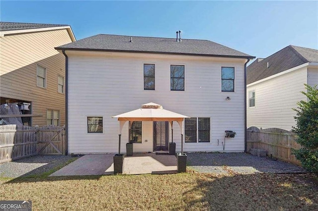 rear view of house featuring a patio area and a yard