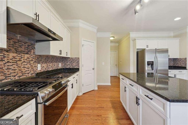 kitchen with appliances with stainless steel finishes and white cabinets