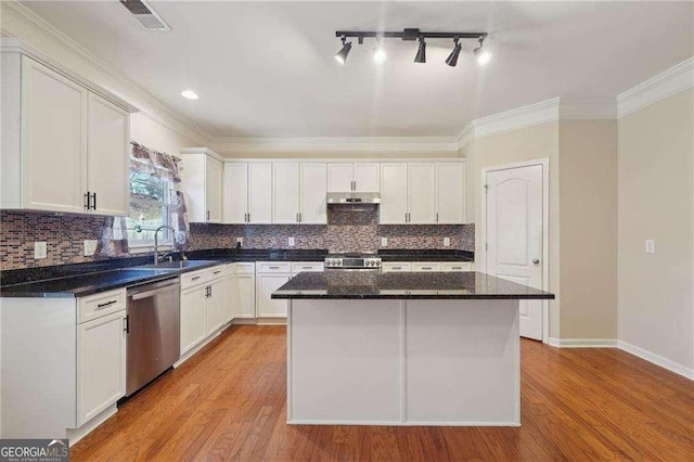 kitchen with sink, white cabinetry, dishwasher, and a kitchen island