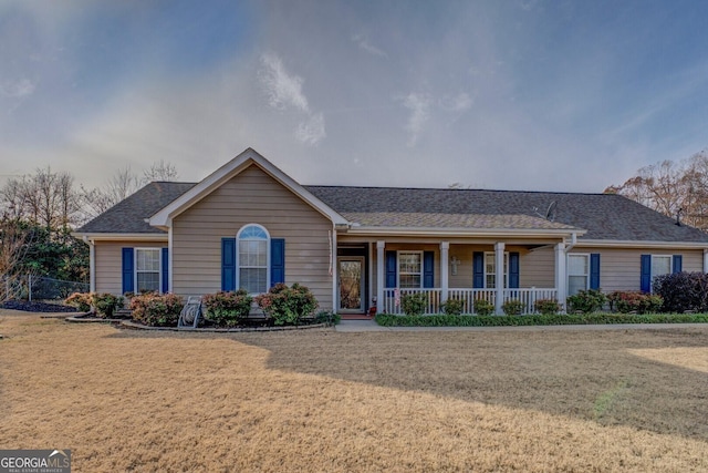 ranch-style home with a porch and a front yard