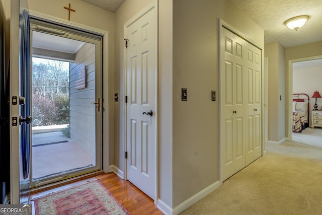 interior space featuring a textured ceiling and light hardwood / wood-style flooring