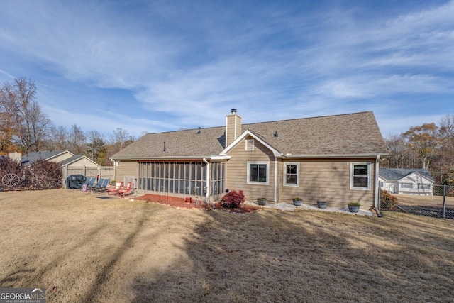 back of property with a lawn and a sunroom