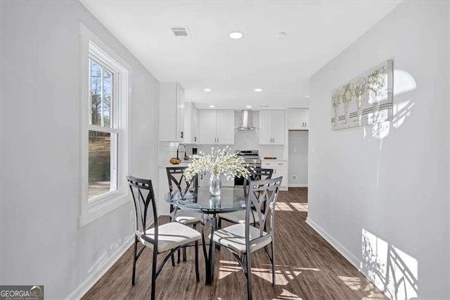 dining area with dark hardwood / wood-style flooring and sink