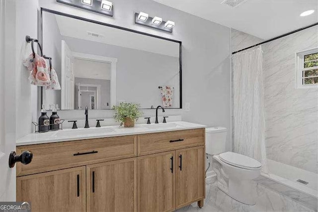 bathroom featuring toilet, curtained shower, and vanity