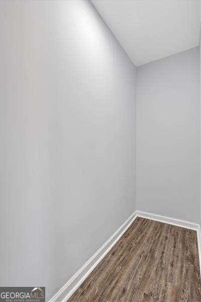 unfurnished room with dark hardwood / wood-style floors