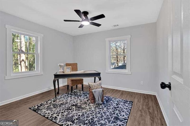 office space with ceiling fan and dark hardwood / wood-style flooring