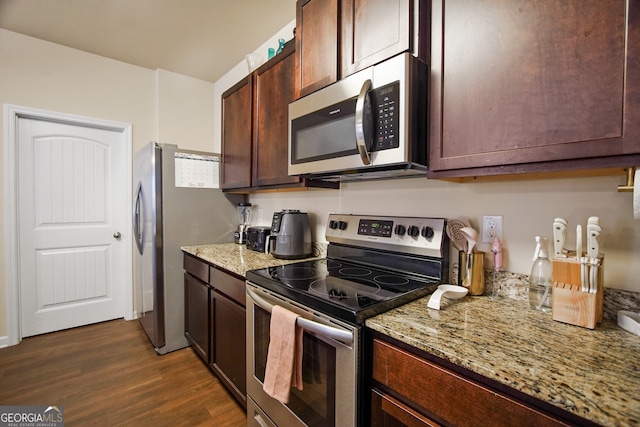 kitchen with light stone countertops, dark brown cabinetry, and appliances with stainless steel finishes