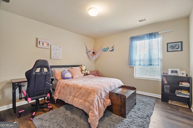 bedroom with dark hardwood / wood-style floors