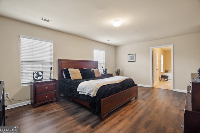 bedroom with dark hardwood / wood-style floors