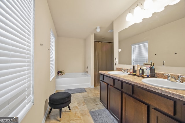 bathroom featuring vanity and a bath