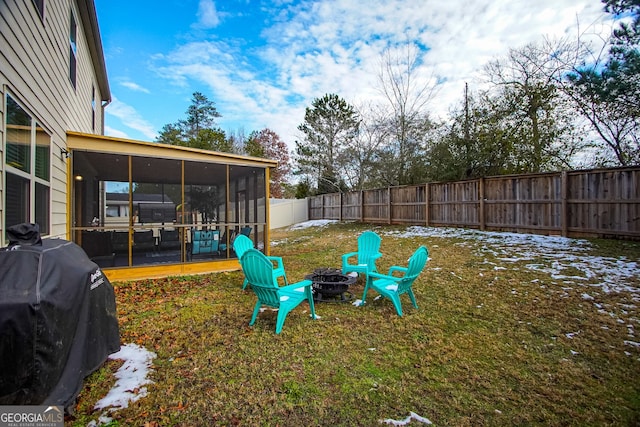 view of yard with a sunroom and a fire pit