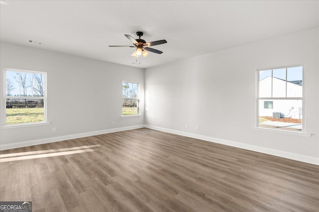 empty room featuring hardwood / wood-style flooring and ceiling fan