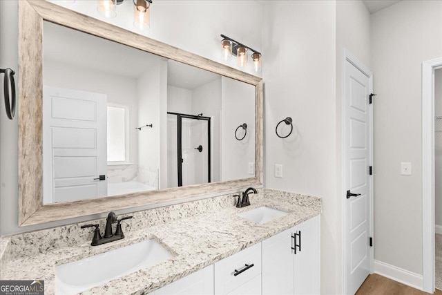 bathroom featuring vanity and a shower with door