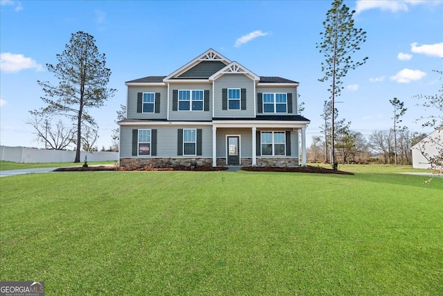 craftsman inspired home with a front yard and covered porch