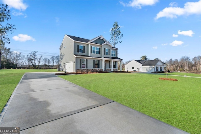 view of front of home featuring cooling unit, a garage, a front yard, and a porch