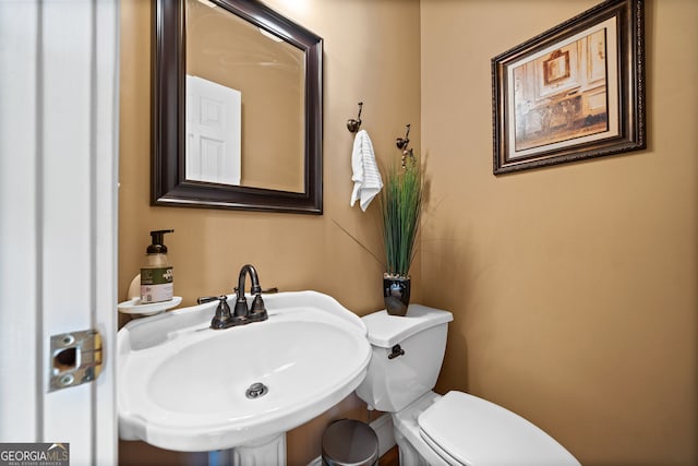 bathroom featuring sink and toilet