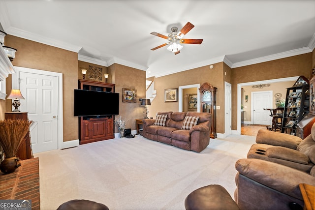 carpeted living room featuring ornamental molding and ceiling fan