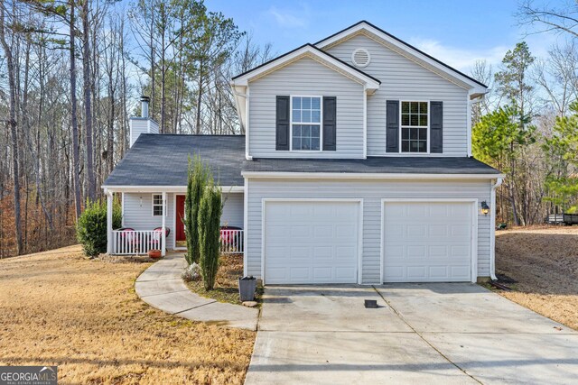 view of front property with covered porch and a garage