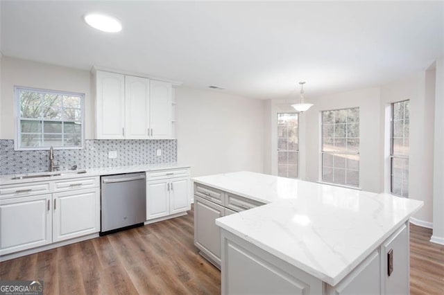 kitchen featuring sink, decorative light fixtures, a center island, white cabinets, and dishwasher