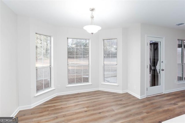 unfurnished dining area with light hardwood / wood-style flooring