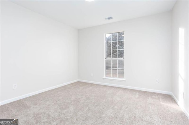 carpeted empty room with plenty of natural light