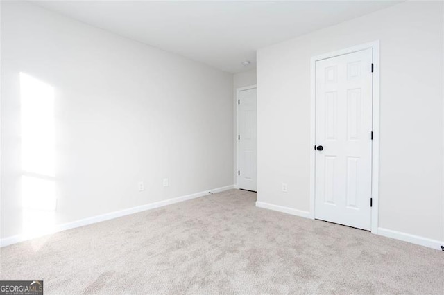 unfurnished bedroom featuring light carpet