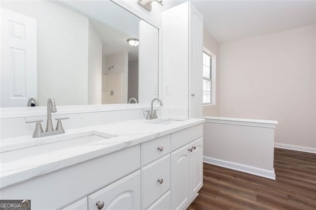 bathroom with hardwood / wood-style flooring and vanity