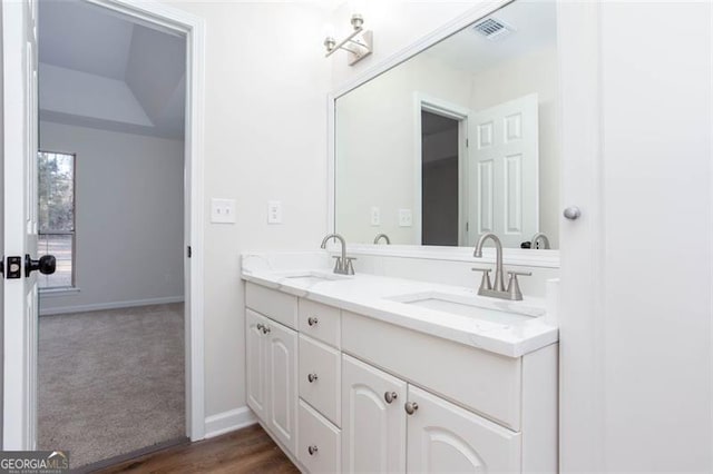 bathroom with vanity and hardwood / wood-style flooring