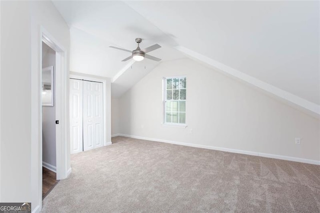 bonus room featuring ceiling fan, vaulted ceiling, and carpet floors