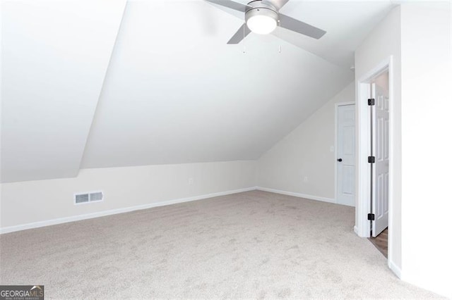 additional living space featuring ceiling fan, light carpet, and lofted ceiling