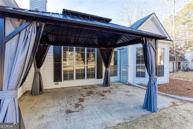 rear view of property featuring a gazebo