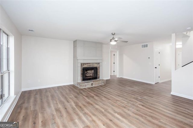 4100 Chanticleer Dr, Kennesaw, GA 30152 - unfurnished living room featuring a ceiling fan, light wood-type flooring, baseboards, and a stone fireplace
