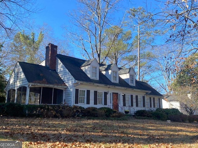 view of property exterior with a sunroom