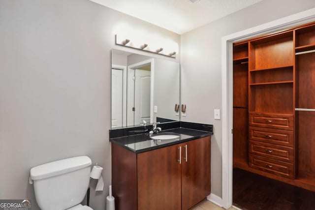 bathroom featuring toilet and vanity