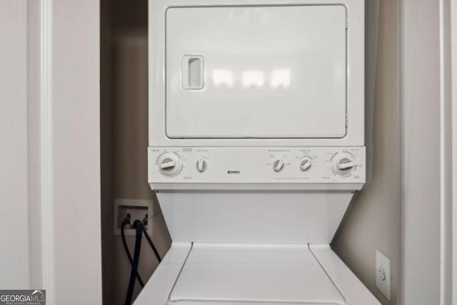 washroom featuring stacked washer / dryer