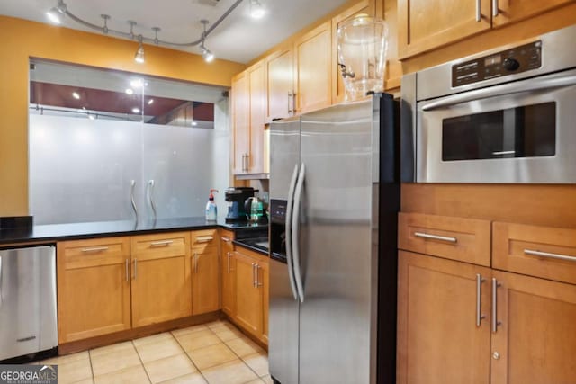 kitchen with appliances with stainless steel finishes and light tile patterned floors