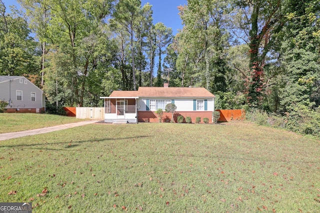 single story home with a front lawn and a sunroom