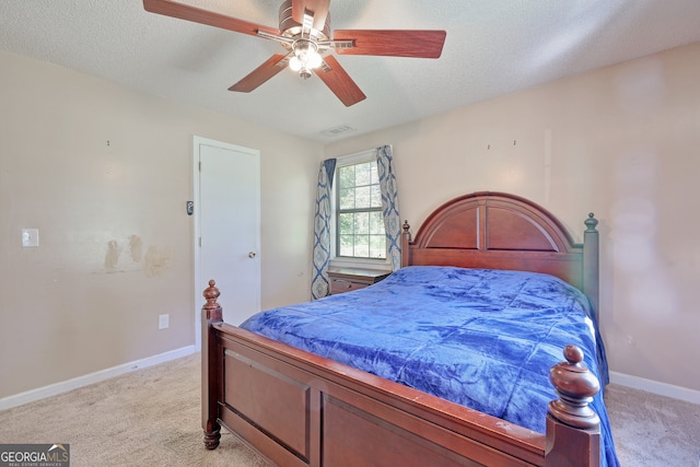 bedroom with light colored carpet, ceiling fan, baseboards, and visible vents