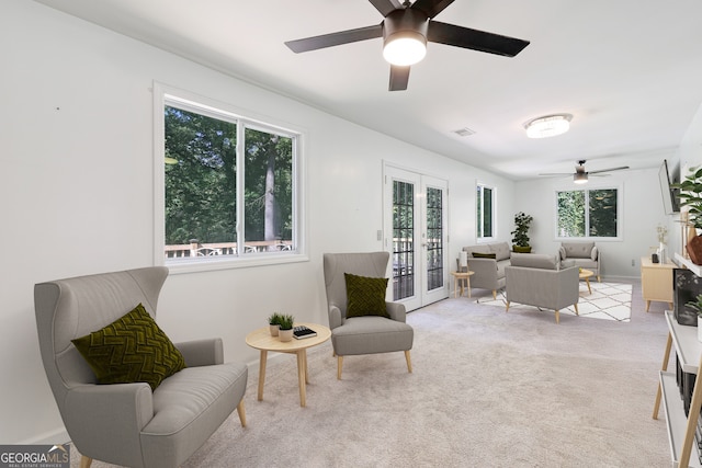 sitting room with ceiling fan, carpet floors, visible vents, and baseboards