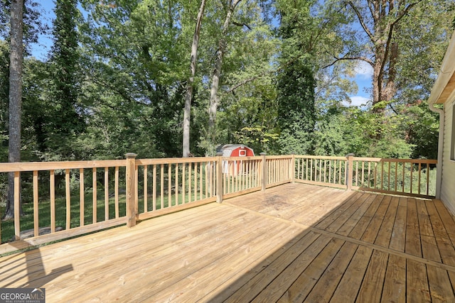 deck featuring an outdoor structure and a shed