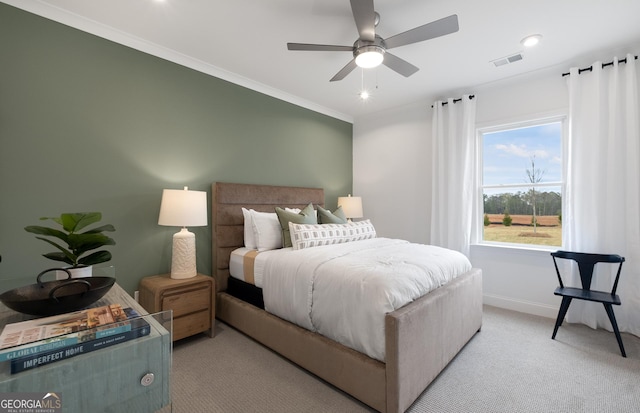 bedroom featuring ceiling fan, light colored carpet, and crown molding